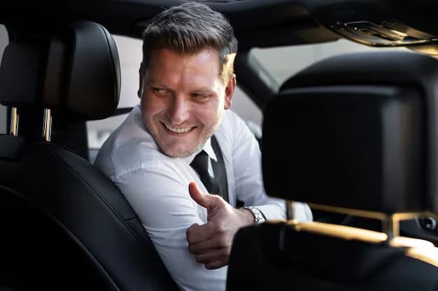 Smiling Schipholride driver in a suit, turned around to greet the passenger