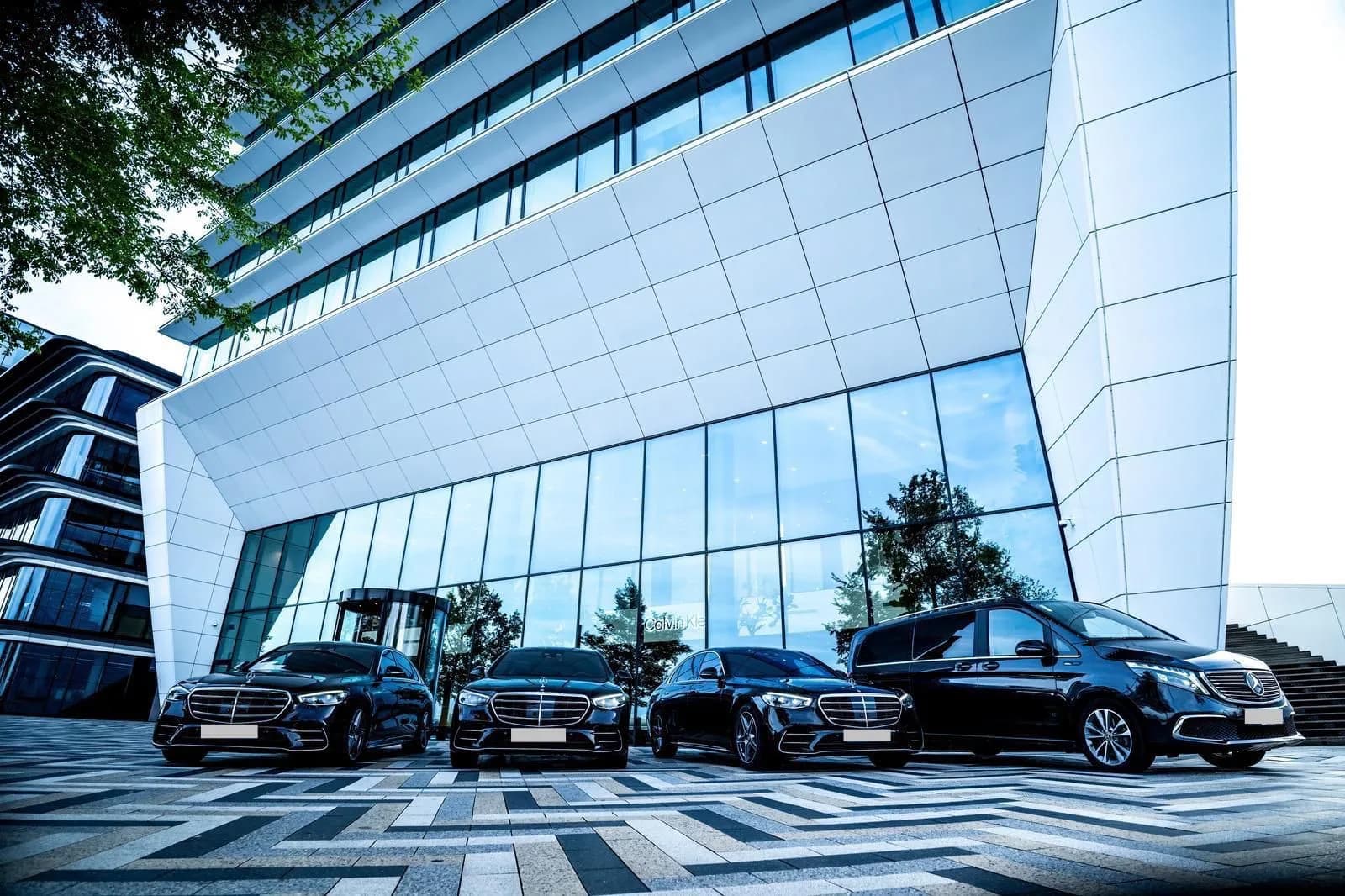 Schipholride Van and VIP vehicles: Mercedes V-Class and S-Class in front of a modern glass office building