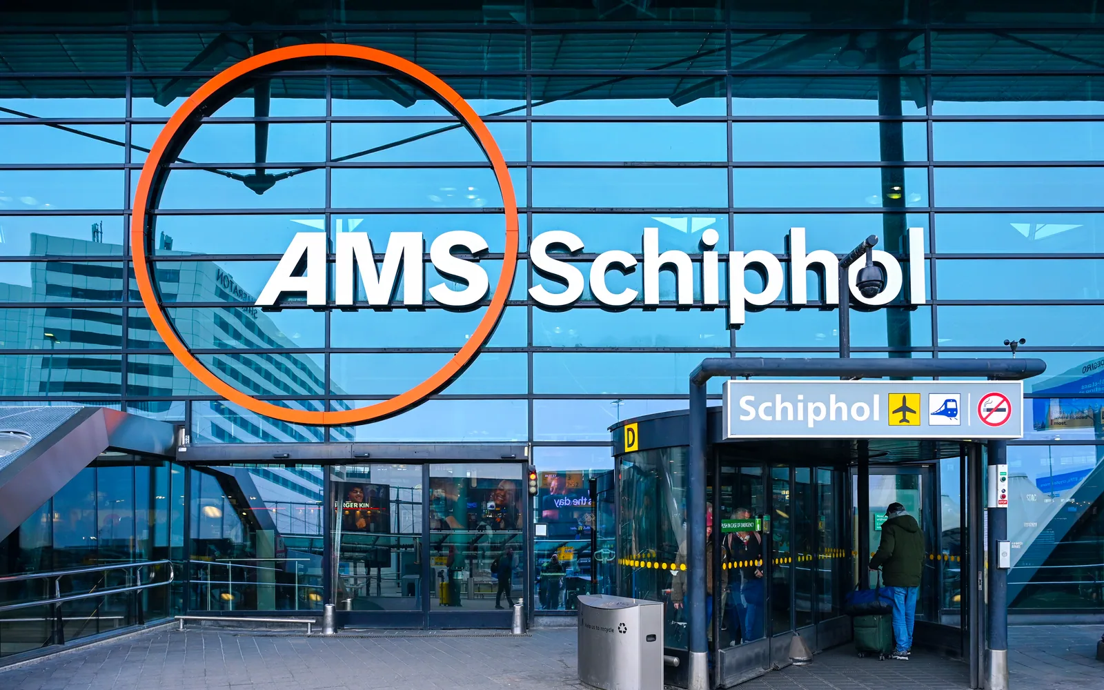 Schiphol Plaza with the AMS sign and orange circle