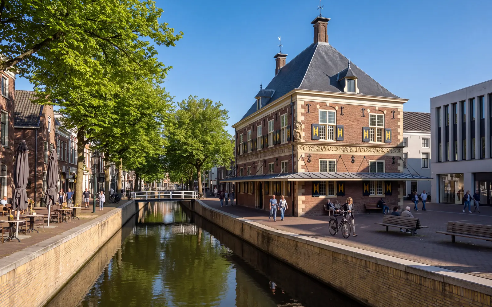 De Waag weigh house by the Nieuwestad canal in Leeuwarden under a blue sky
