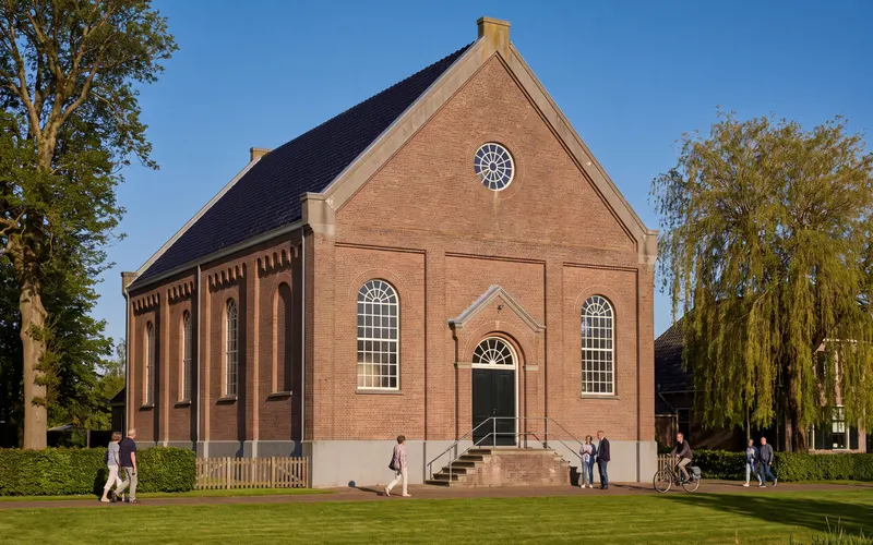 The 1899 Mennonite church in Middelie, with a weeping willow beside it