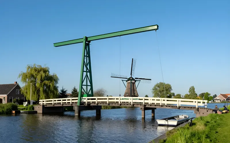 The drawbridge over the Ringvaart canal at Vijfhuizen with its green lifting beam, and the Vijfhuizer windmill beyond